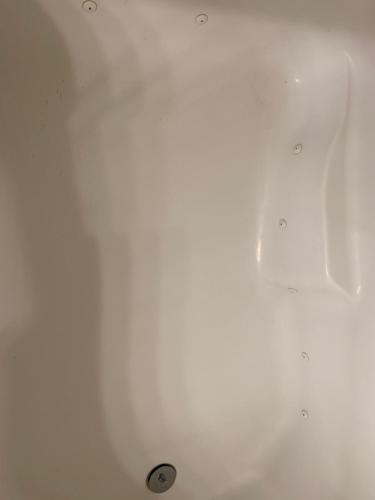 a white bath tub with a drain in it at LuxHome Suites in Mansion in Riverside