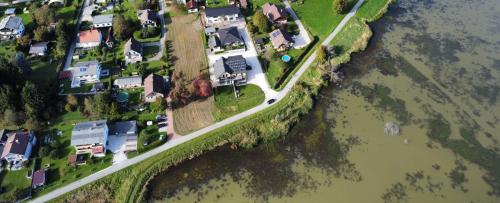 an aerial view of houses on an island in the water at Ferienhaus Am-moore in Steindorf am Ossiacher See