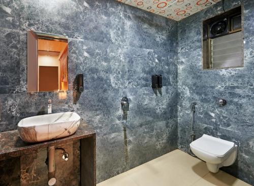 a bathroom with a sink and a toilet at Pawna Mountain View 4BHK in Āmbavna