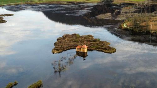 an island in the middle of a body of water at Ferienhaus Am-moore in Steindorf am Ossiacher See