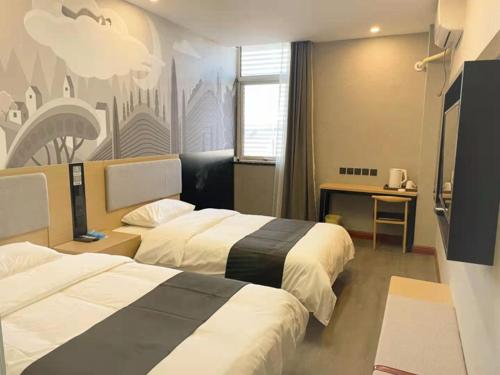 a hotel room with two beds and a desk at Thank Inn Chain Hotel hebei langfang gymnasium in Langfang