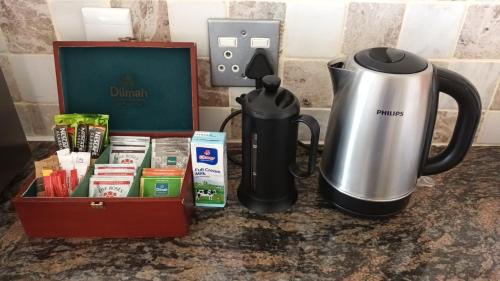 a coffeemaker and a coffee maker next to a coffeemaker at Castellon Boutique Hotel in Table View