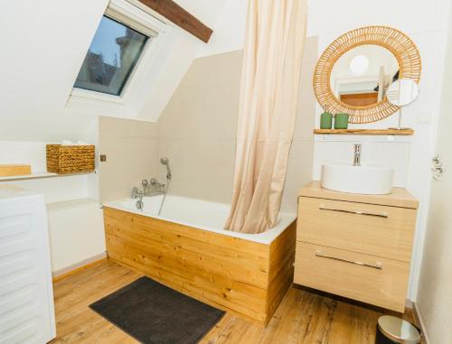 a bathroom with a wooden tub and a sink at Nid douillet La Cour du Dauphin, Vue cathédrale imprenable in Laon