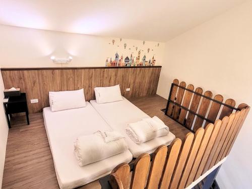 a bedroom with a bed and a table and chairs at Yuzhou Garden B&B in Taitung City