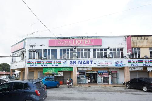 a large building with cars parked in front of it at Jerteh Hotel, Terengganu in Jertih