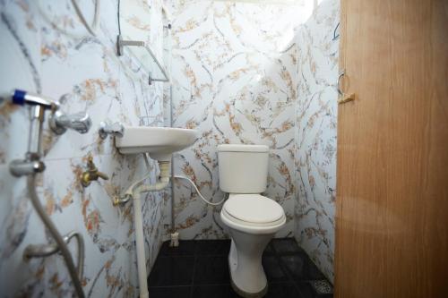 a bathroom with a toilet and a sink at Jerteh Hotel, Terengganu in Jertih