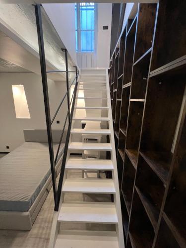 a staircase leading up to a room with bunk beds at Pere Lachaise Apartments in Paris