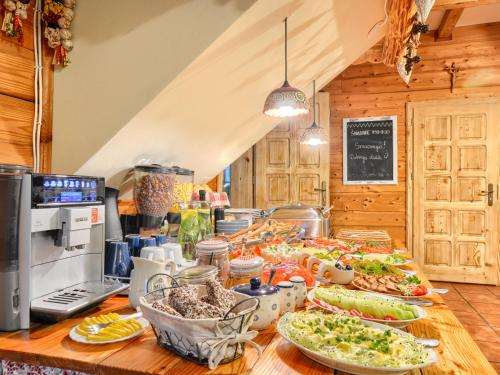 a table with many plates of food on it at Gościniec Rabe - Agro&SPA in Ustrzyki Dolne