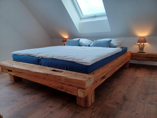 a bedroom with a large bed with a wooden frame at Hof Schütterle in Friedrichshafen