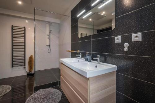 a bathroom with a sink and a mirror at Apartment Panorama 35C in Donovaly