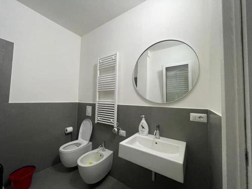 a bathroom with a sink and a toilet and a mirror at Nuovo a 40 passi dal mare. A casa di “Bicca” in Tortoreto Lido