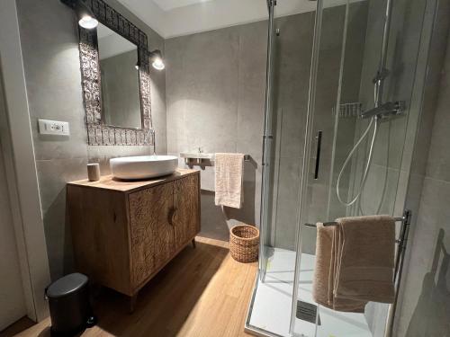 a bathroom with a sink and a shower at HouSmart Senzanome 9/3 in Bologna