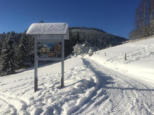 a sign in the snow on a snow covered road at Penzion Modrý Pavilon in Dolní Malá Úpa