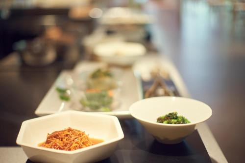 a table topped with bowls of food on a table at Sansuiso Tsuchiyu Spa in Fukushima