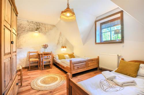 a bedroom with two beds and a dining room at Gościniec Rabe - Agro&SPA in Ustrzyki Dolne