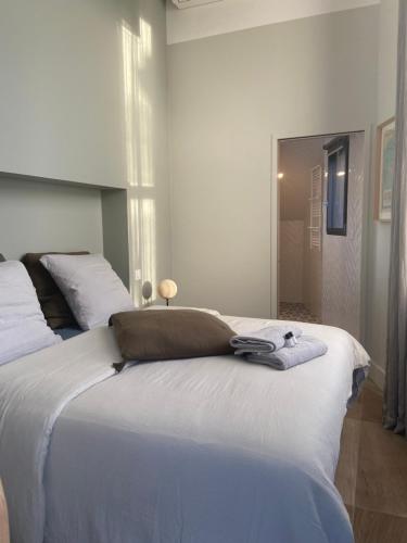 a bedroom with a large white bed and a mirror at La Suite du Héron nantais in Nantes