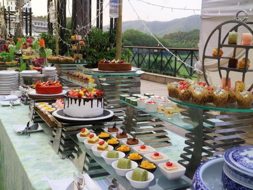 a buffet of desserts and cakes on a table at Mission Hills Hotel Resorts Dongguan in Dongguan