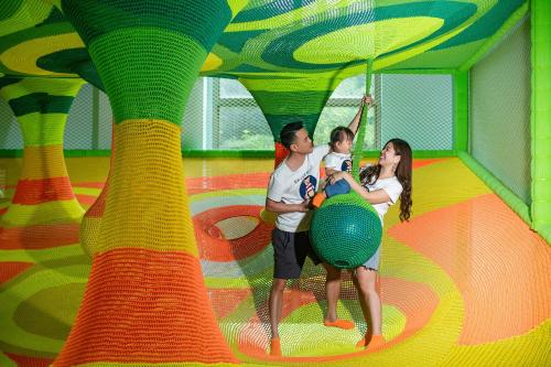 a boy and a girl playing in a play gym at Mission Hills Hotel Resorts Dongguan in Dongguan