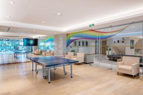 a ping pong table in a room with a rainbow mural at Mission Hills Hotel Resorts Dongguan in Dongguan