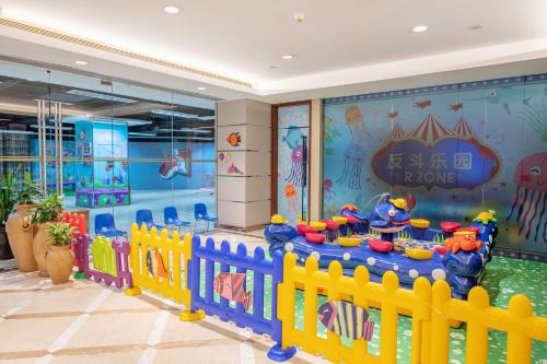a childrens room with a pool and a play area at Mission Hills Hotel Resorts Dongguan in Dongguan