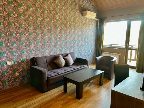 a living room with a couch and a table at Dragoman Hotel in Dragoman