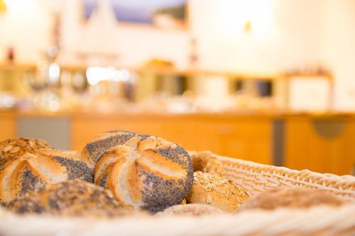 a basket filled with breads on a table at Villa Osada in Binz