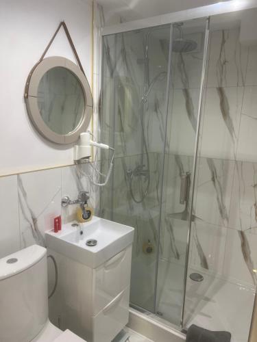 a bathroom with a shower and a toilet and a sink at Apartamenty u Ewy - EUROS in Ustka