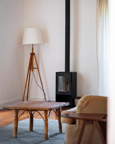 a living room with a table and a lamp at Wine Tourism - Quinta do Ameal in Refoios do Lima