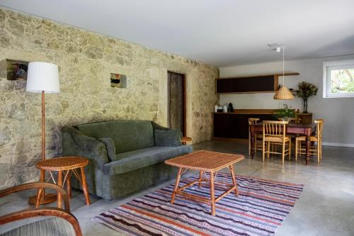 a living room with a couch and a table at Wine Tourism - Quinta do Ameal in Refoios do Lima