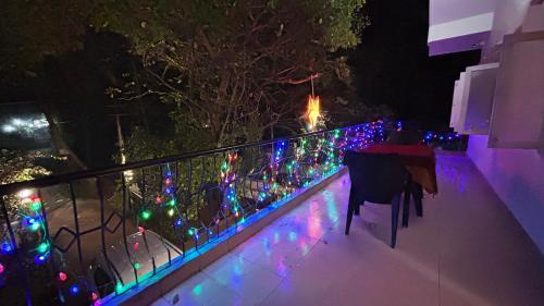 a fence with christmas lights on it at night at Muffys Holiday Home in Old Goa