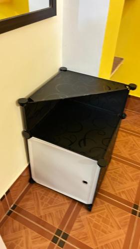 a black and white box sitting on the floor at Muffys Holiday Home in Old Goa