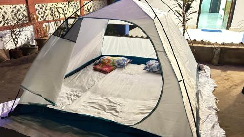 a white tent with two pillows in it at Muffys Holiday Home in Old Goa