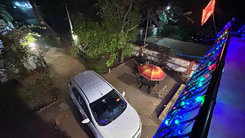 a white car parked in a parking lot at night at Muffys Holiday Home in Old Goa
