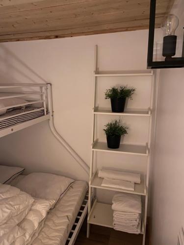 a bedroom with two bunk beds and two potted plants at Cozy cabin with an amazing view in Åre