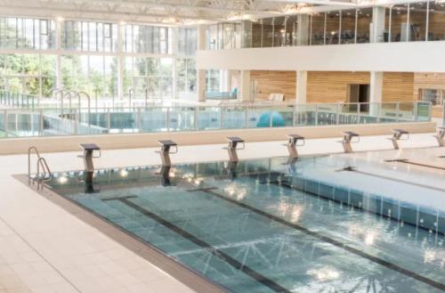 a large swimming pool in a large building at Evasion Paris-Disney in Noisy-le-Grand