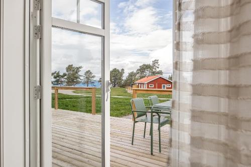 a sliding glass door leading to a patio with a table and chairs at Stora Frögården in Mörbylånga
