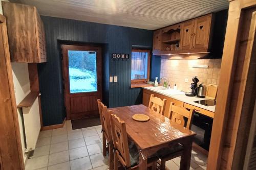 een keuken met een houten tafel en een eetkamer bij Gîte Cœur de Haute-Savoie in Viuz-en-Sallaz