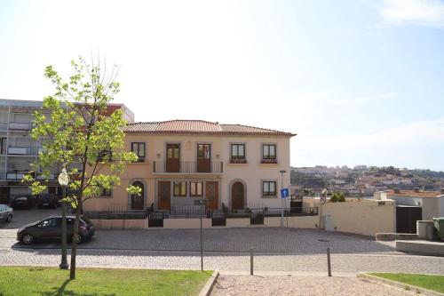 a large house with a car parked in front of it at Casa do Pilar - D. Luís I in Vila Nova de Gaia