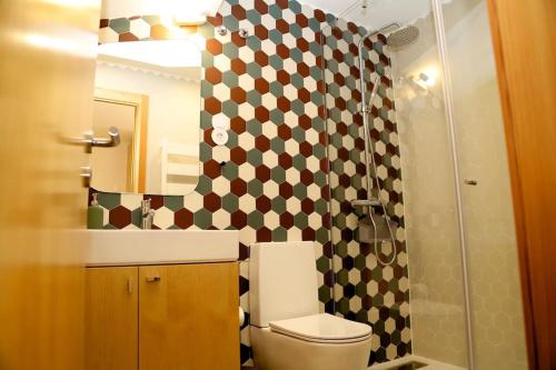 a bathroom with a toilet and a sink and a shower at Casa do Pilar - D. Luís I in Vila Nova de Gaia