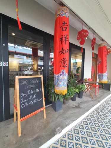 a restaurant with a sign in front of a building at Amazing Rooms in Semporna