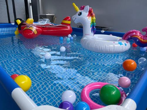 a pool with toys and a toy unicorn in it at TOWN 13Px 5R4B V KIDS POOL & KTV & JACCUZI SPA & POOL TABLE NEAR USM & LAM WAH EE HOSPITAL & HAN CHIANG HIGH SCHOOL in Gelugor