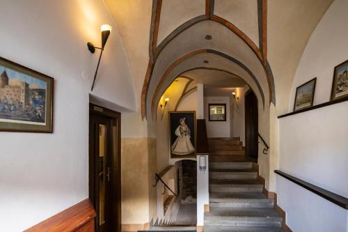 a hallway of a building with a stairway at Hotel Bílá Paní in Jindrichuv Hradec