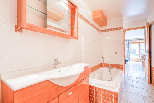 a bathroom with a sink and a bath tub at Gîte des Cascades in Sixt