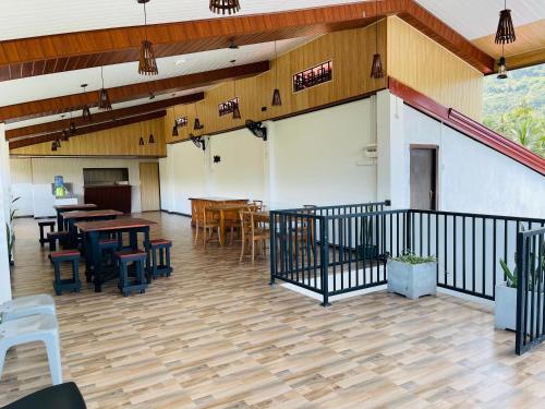 a patio with tables and chairs in a building at Ama Residence in Matale