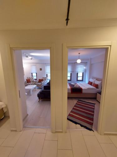 a room with a bed and a living room at CLASS SUİT RESİDENCE in Canakkale