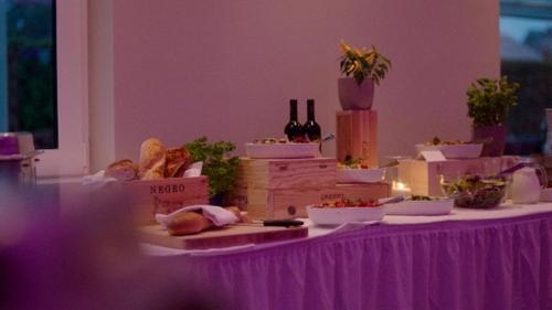 a purple table with food and bottles of wine at Landgasthaus Lenniger in Büren