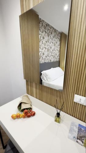 a room with a table with a mirror and a bed at Hotel Belvedere in Roccaraso