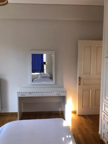 a bedroom with a white bed and a mirror at Zack's Grande in Athens