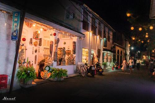 a store on a city street at night at Southern Comforts - Galle Fort in Galle