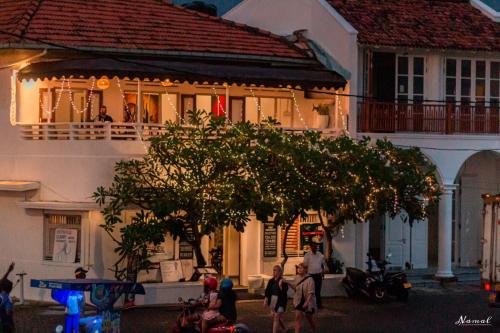 a group of people walking in front of a building at Southern Comforts - Galle Fort in Galle